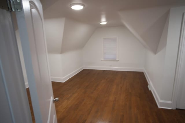 additional living space featuring vaulted ceiling, baseboards, and wood finished floors