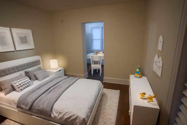 bedroom featuring dark wood-type flooring and baseboards