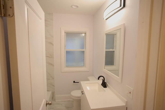 full bath featuring baseboards, toilet, marble finish floor, walk in shower, and vanity