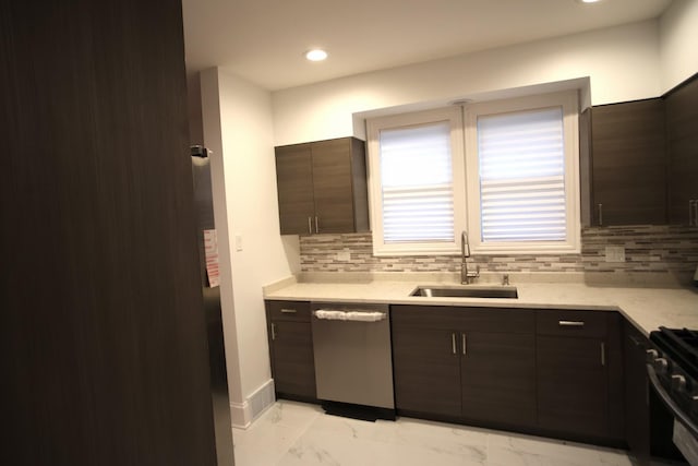 kitchen with a sink, marble finish floor, stainless steel dishwasher, backsplash, and gas stove