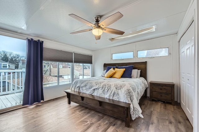 bedroom with a ceiling fan and wood finished floors