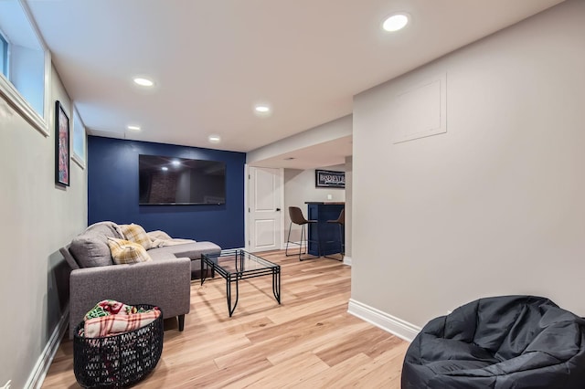 sitting room featuring recessed lighting, a dry bar, light wood-style flooring, and baseboards