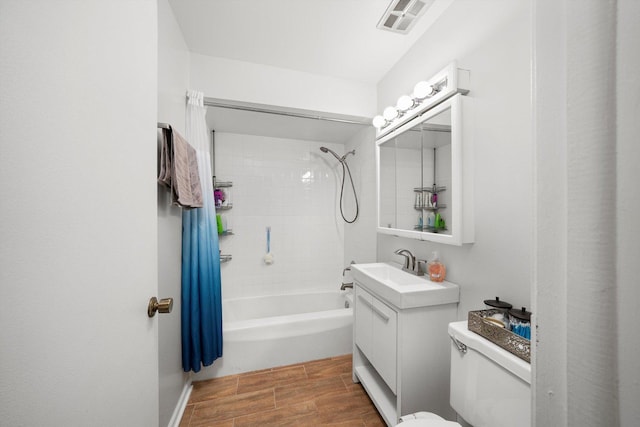 full bath featuring visible vents, toilet, tub / shower combination, vanity, and wood finish floors