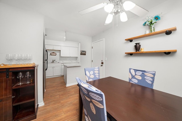 dining area with a ceiling fan, baseboards, and wood finished floors