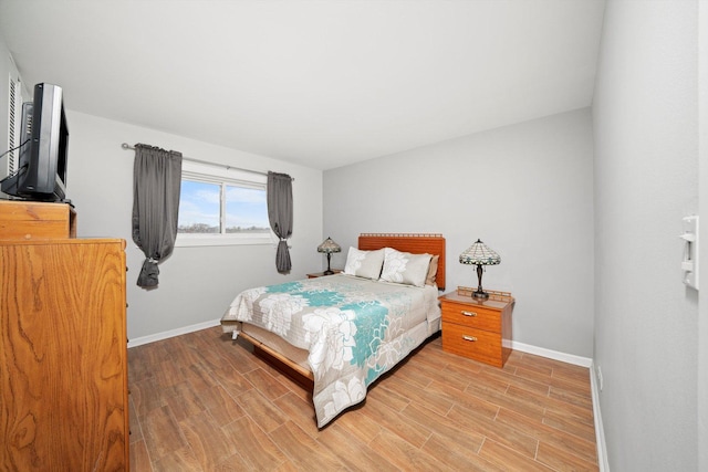 bedroom featuring light wood-type flooring and baseboards