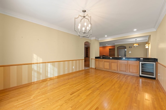 2811 Haven Ct, Naperville, IL 60564 - kitchen featuring crown molding, dark countertops, arched walkways, light wood-type flooring, and beverage cooler