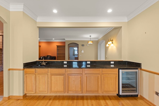 2811 Haven Ct, Naperville, IL 60564 - kitchen featuring a sink, beverage cooler, light wood-style flooring, dark stone countertops, and arched walkways