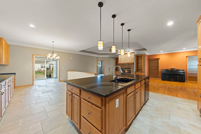 2811 Haven Ct, Naperville, IL 60564 - kitchen featuring open floor plan, a sink, an island with sink, stone tile flooring, and a fireplace