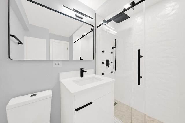 full bathroom with a stall shower, vanity, and toilet