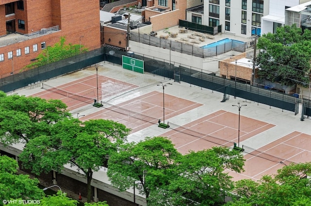 view of tennis court featuring fence