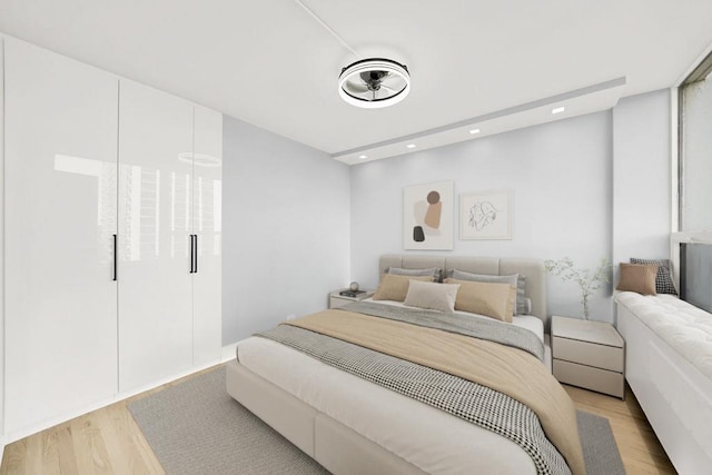 bedroom featuring light wood-type flooring and recessed lighting