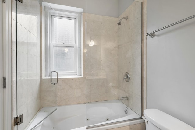 bathroom with a combined bath / shower with jetted tub and toilet