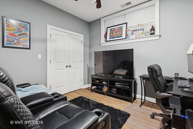 office featuring visible vents, baseboards, ceiling fan, and wood finished floors