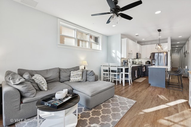 living room featuring visible vents, recessed lighting, ceiling fan, and wood finished floors