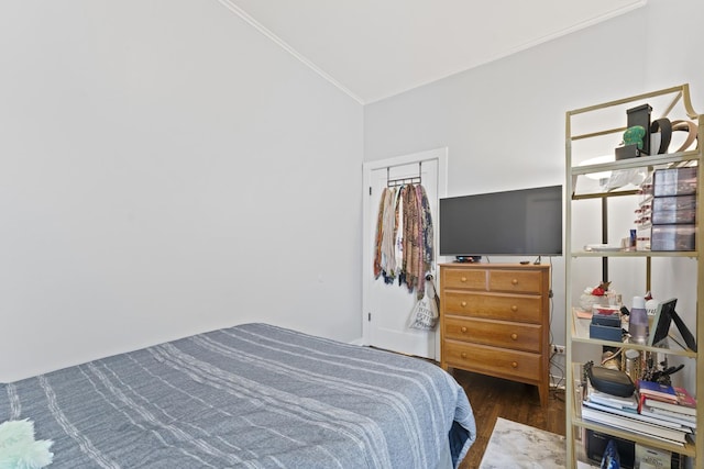 bedroom featuring crown molding and wood finished floors