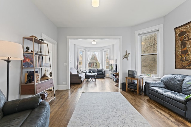 living area featuring baseboards and wood finished floors