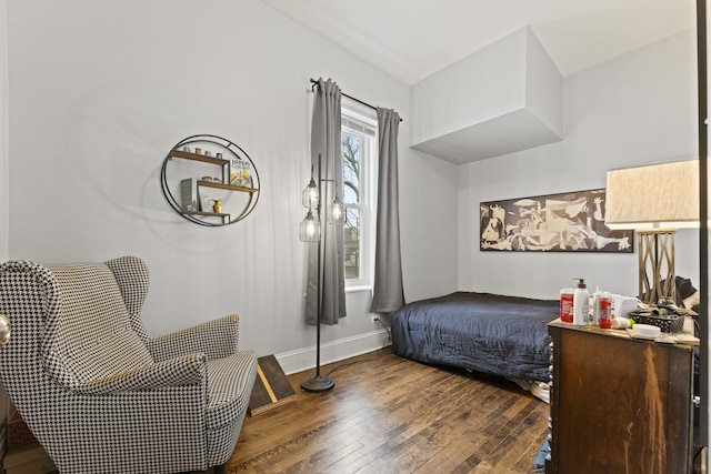 bedroom with baseboards and hardwood / wood-style floors