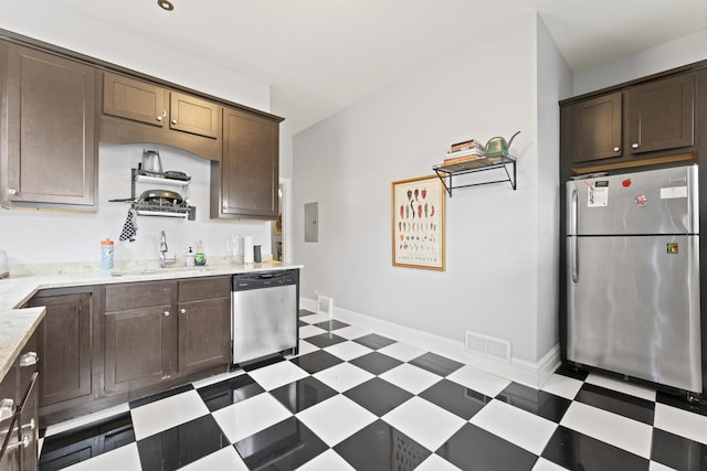 kitchen featuring stainless steel appliances, a sink, visible vents, and tile patterned floors