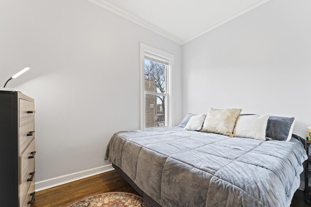 bedroom with crown molding, baseboards, and dark wood-type flooring