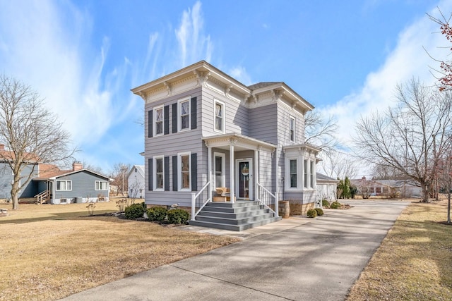 italianate-style house featuring a front yard