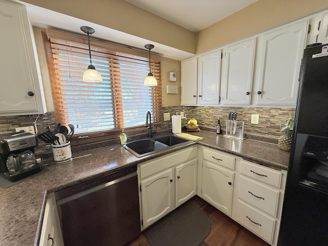 kitchen with dishwasher, backsplash, a sink, and freestanding refrigerator