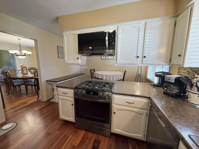 kitchen featuring appliances with stainless steel finishes, white cabinets, and dark wood finished floors