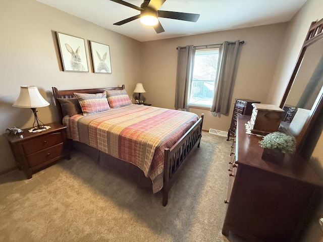 bedroom with ceiling fan, visible vents, and light colored carpet