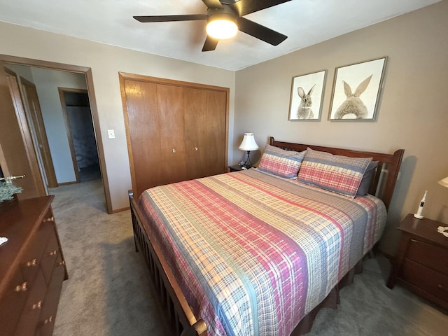 carpeted bedroom featuring ceiling fan, a closet, and baseboards