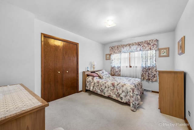 carpeted bedroom with a closet