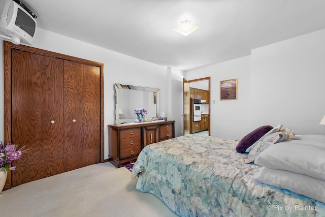 bedroom featuring light colored carpet