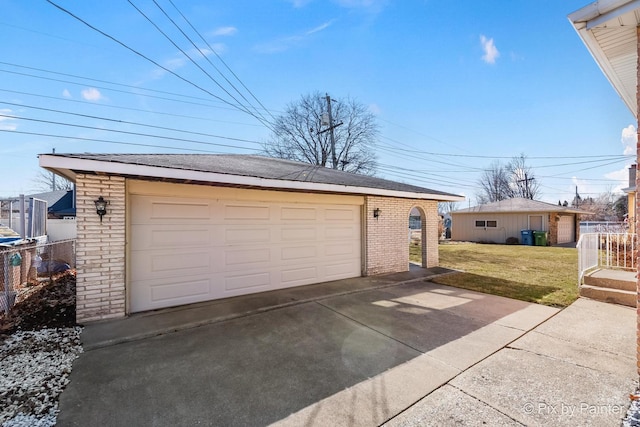 detached garage featuring fence