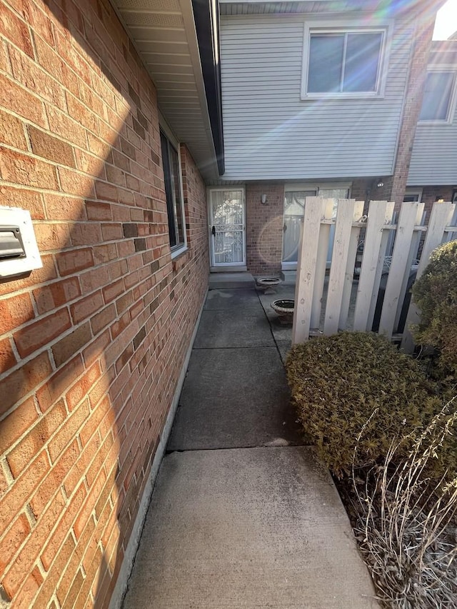 view of side of home with brick siding