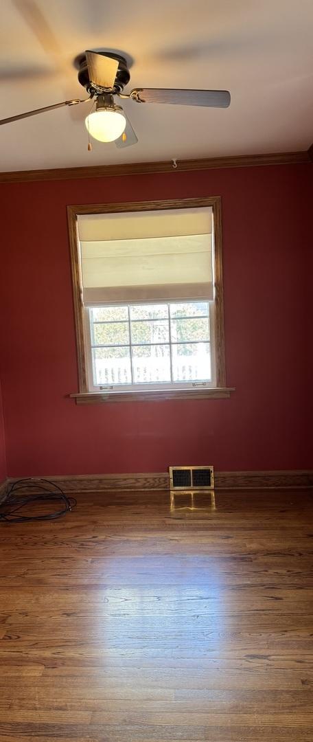 4036 Linden Ave, Western Springs, IL 60558 - unfurnished room featuring plenty of natural light, wood finished floors, visible vents, and crown molding