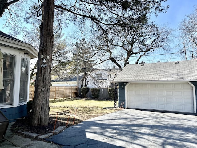 4036 Linden Ave, Western Springs, IL 60558 - exterior space featuring fence, a detached garage, and a shingled roof