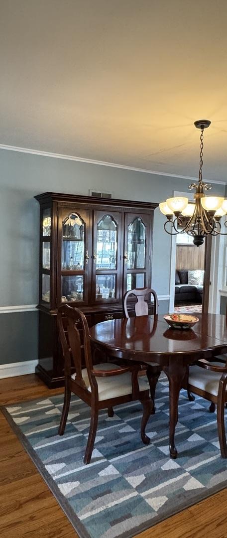 4036 Linden Ave, Western Springs, IL 60558 - dining room with crown molding, baseboards, a notable chandelier, and dark wood finished floors