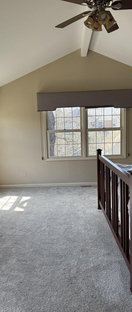 4036 Linden Ave, Western Springs, IL 60558 - carpeted spare room with ceiling fan, baseboards, lofted ceiling with beams, and plenty of natural light