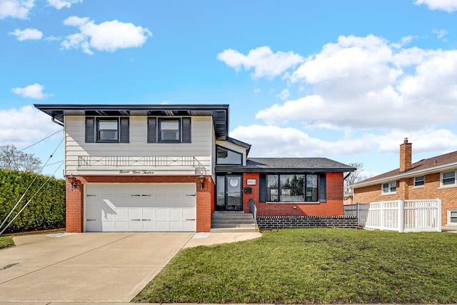 split level home featuring a front yard, fence, driveway, a garage, and brick siding