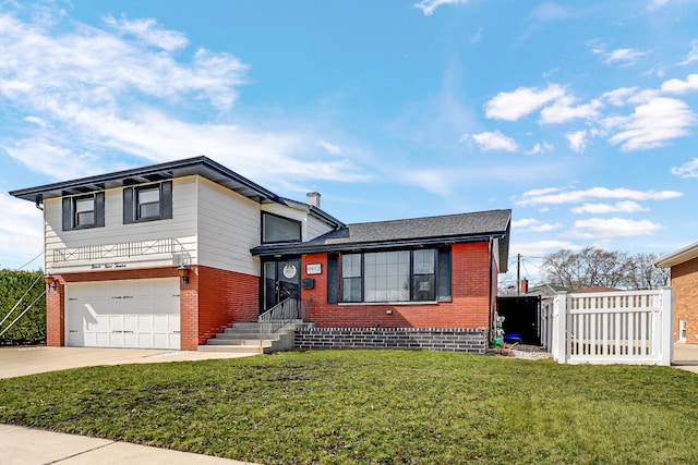 split level home with fence, driveway, an attached garage, a front lawn, and brick siding