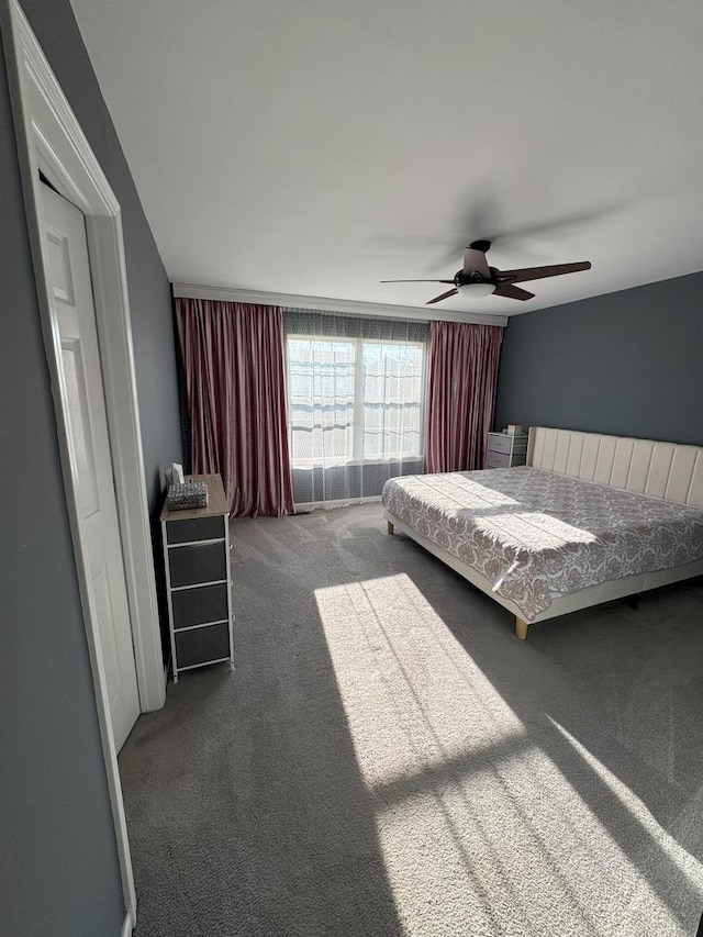 unfurnished bedroom with carpet flooring and a ceiling fan