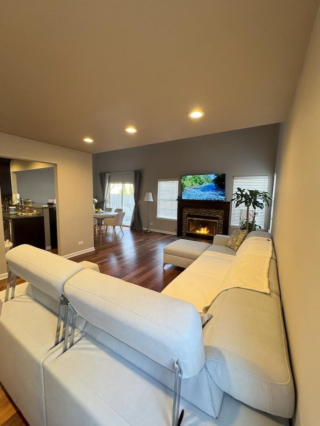 living room with baseboards, wood finished floors, and recessed lighting