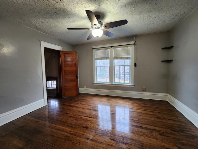 spare room featuring ceiling fan, a textured ceiling, baseboards, and hardwood / wood-style flooring