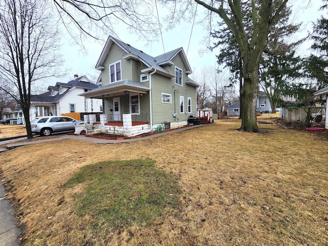 view of front of home with a front yard and covered porch