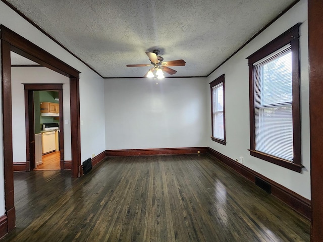 unfurnished room featuring dark wood finished floors, ornamental molding, ceiling fan, a textured ceiling, and baseboards