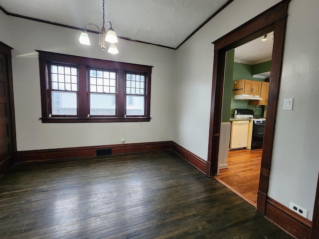 unfurnished dining area featuring baseboards, visible vents, dark wood finished floors, a textured ceiling, and crown molding