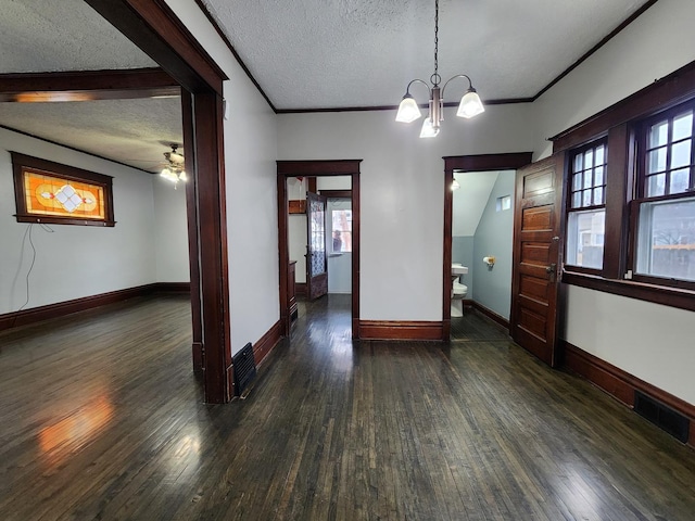 unfurnished dining area with baseboards, visible vents, a textured ceiling, and hardwood / wood-style floors