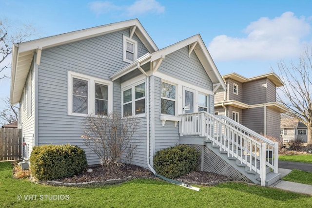 exterior space featuring a front lawn and fence