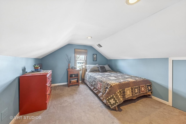 bedroom with visible vents, carpet floors, baseboards, and vaulted ceiling