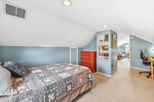 carpeted bedroom featuring vaulted ceiling, baseboards, and visible vents