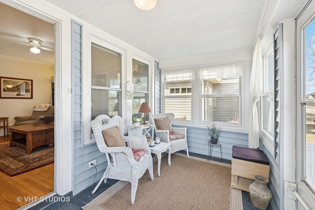 sunroom featuring ceiling fan