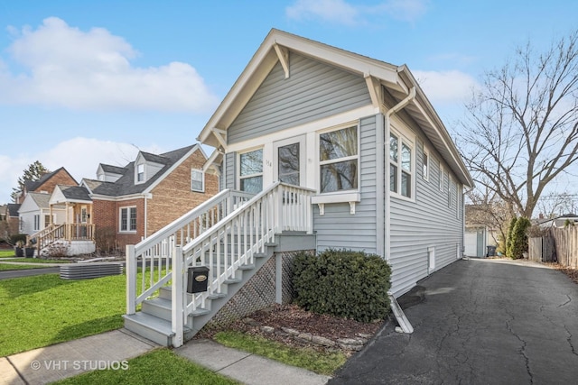 view of front facade featuring a front yard and fence